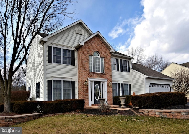 504 Ridge Dr, Douglassville, PA 19518 - colonial inspired home featuring an attached garage, a front lawn, and brick siding