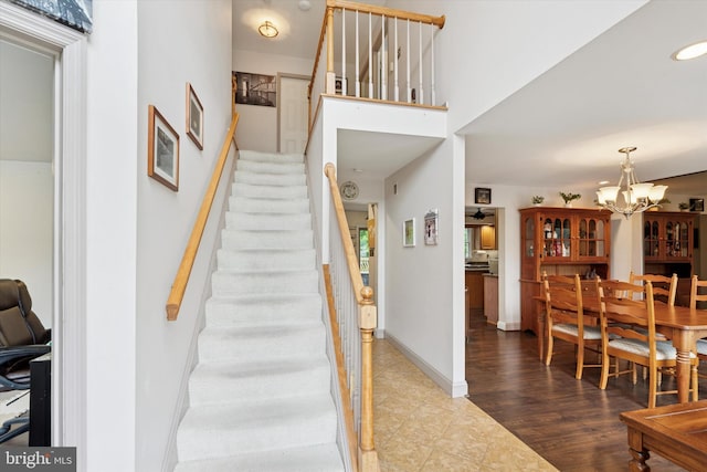 504 Ridge Dr, Douglassville, PA 19518 - staircase featuring a chandelier, baseboards, and tile patterned flooring