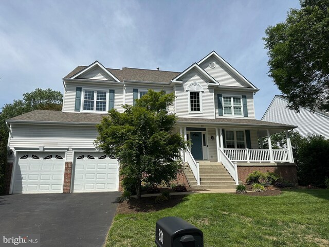 831 Macalister Dr SE, Leesburg, VA 20175 - view of front of house featuring driveway, covered porch, a front lawn, and an attached garage