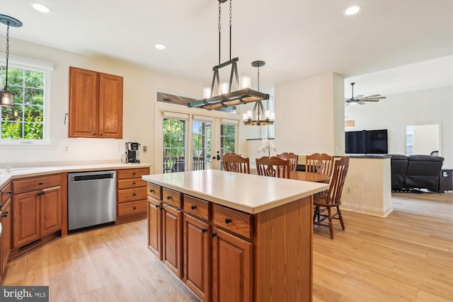831 Macalister Dr SE, Leesburg, VA 20175 - kitchen featuring dishwasher, brown cabinetry, a chandelier, light wood-style flooring, and hanging light fixtures