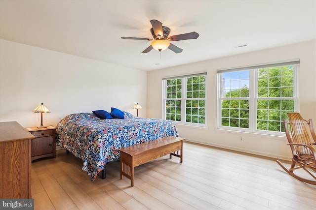 831 Macalister Dr SE, Leesburg, VA 20175 - bedroom featuring multiple windows, light wood-style floors, baseboards, and a ceiling fan