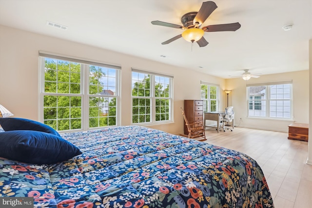 831 Macalister Dr SE, Leesburg, VA 20175 - bedroom with wood finished floors, a ceiling fan, and baseboards