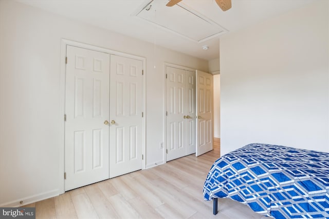 831 Macalister Dr SE, Leesburg, VA 20175 - bedroom featuring attic access, wood finished floors, multiple closets, baseboards, and a ceiling fan