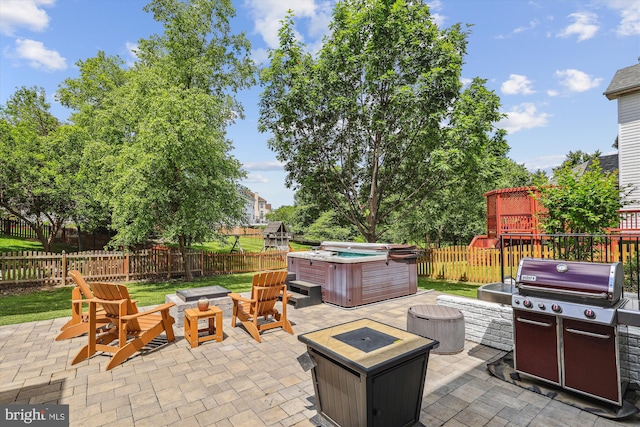 831 Macalister Dr SE, Leesburg, VA 20175 - fenced backyard featuring an outdoor fire pit, a hot tub, a patio, and a grill