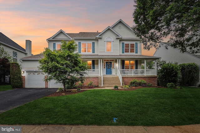 831 Macalister Dr SE, Leesburg, VA 20175 - view of front of home with driveway, a porch, and a front lawn