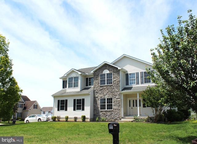 view of front facade with a front lawn and stone siding