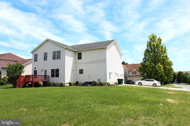 view of side of property with a lawn, a wooden deck, and driveway