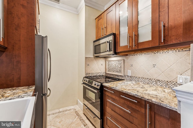 306 S 13th St Unit 8, Philadelphia, PA 19107 - kitchen featuring stainless steel appliances, ornamental molding, glass insert cabinets, light stone countertops, and tasteful backsplash