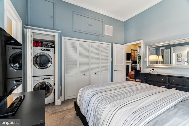 306 S 13th St Unit 8, Philadelphia, PA 19107 - bedroom featuring stacked washer and clothes dryer, carpet flooring, a closet, and crown molding