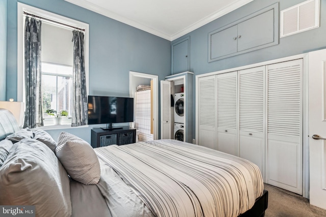 306 S 13th St Unit 8, Philadelphia, PA 19107 - carpeted bedroom featuring stacked washer / dryer, crown molding, and a closet