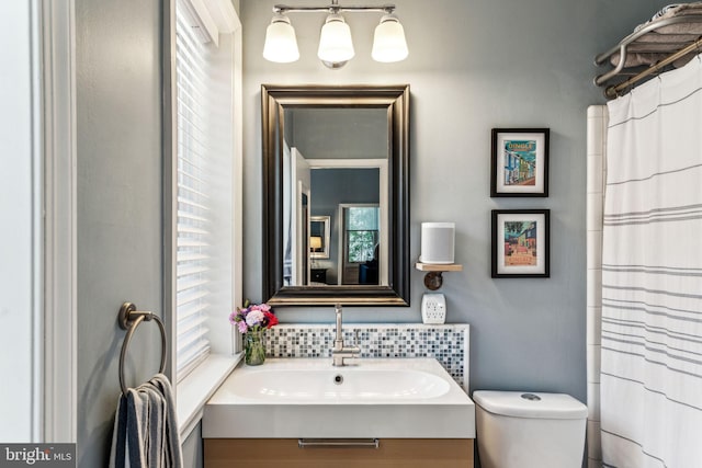 306 S 13th St Unit 8, Philadelphia, PA 19107 - full bath featuring healthy amount of natural light, vanity, toilet, and decorative backsplash