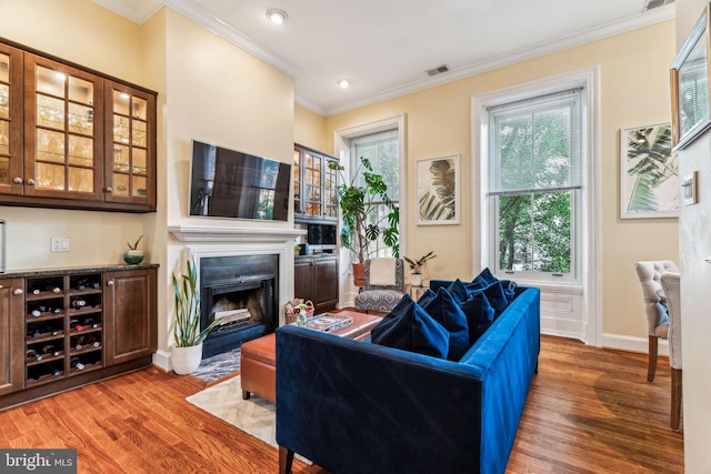 306 S 13th St Unit 8, Philadelphia, PA 19107 - living room featuring wood finished floors, ornamental molding, healthy amount of natural light, baseboards, and a fireplace with flush hearth