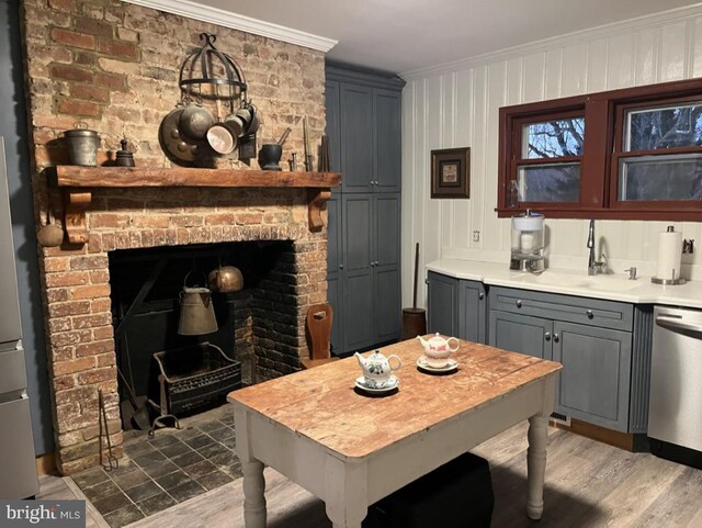 322 Main St E, Fincastle, VA 24090 - kitchen with stainless steel dishwasher, ornamental molding, gray cabinets, a brick fireplace, and light countertops