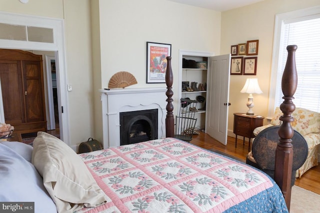 322 Main St E, Fincastle, VA 24090 - bedroom with a fireplace and wood finished floors