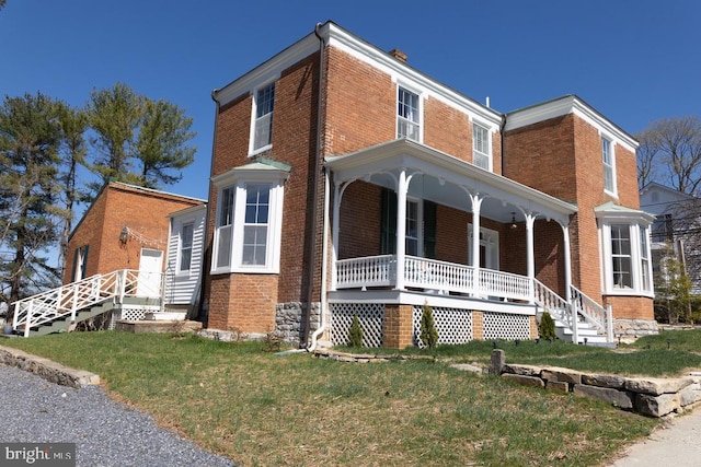 322 Main St E, Fincastle, VA 24090 - view of front facade featuring a porch, brick siding, and a front lawn