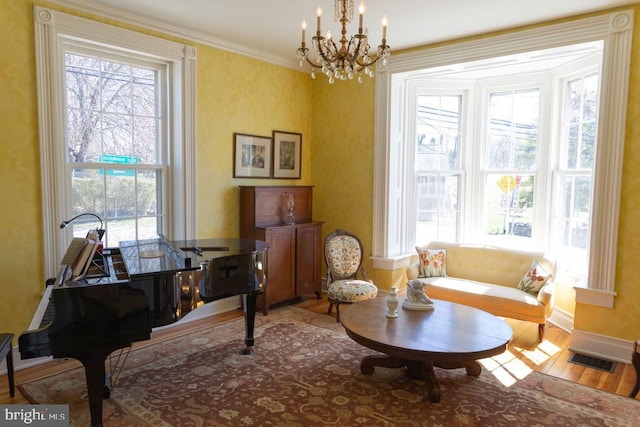 322 Main St E, Fincastle, VA 24090 - living area with wood finished floors, a chandelier, baseboards, and crown molding