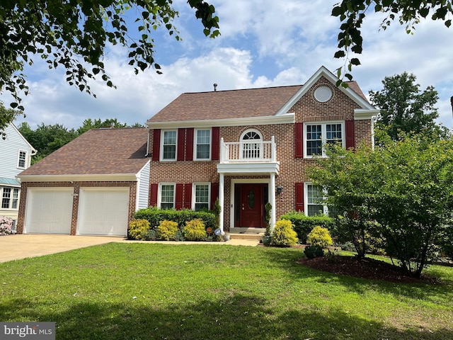 colonial house featuring a garage, brick siding, a front yard, and concrete driveway