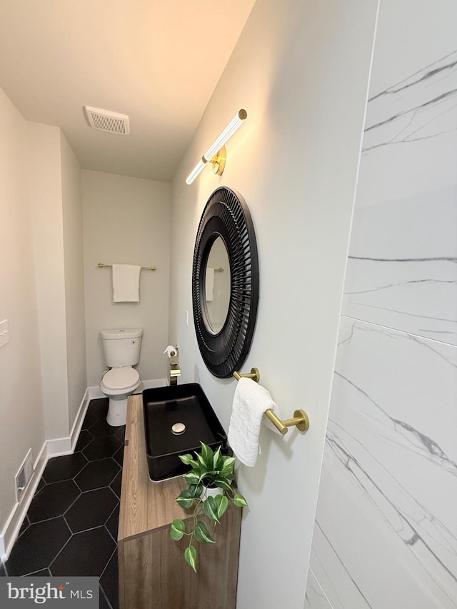 2112 Llewelyn Ave, Baltimore, MD 21213 - bathroom featuring toilet, baseboards, and tile patterned floors