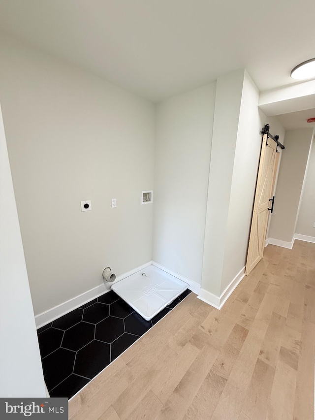 2112 Llewelyn Ave, Baltimore, MD 21213 - laundry room featuring a barn door, baseboards, light wood-type flooring, and hookup for an electric dryer