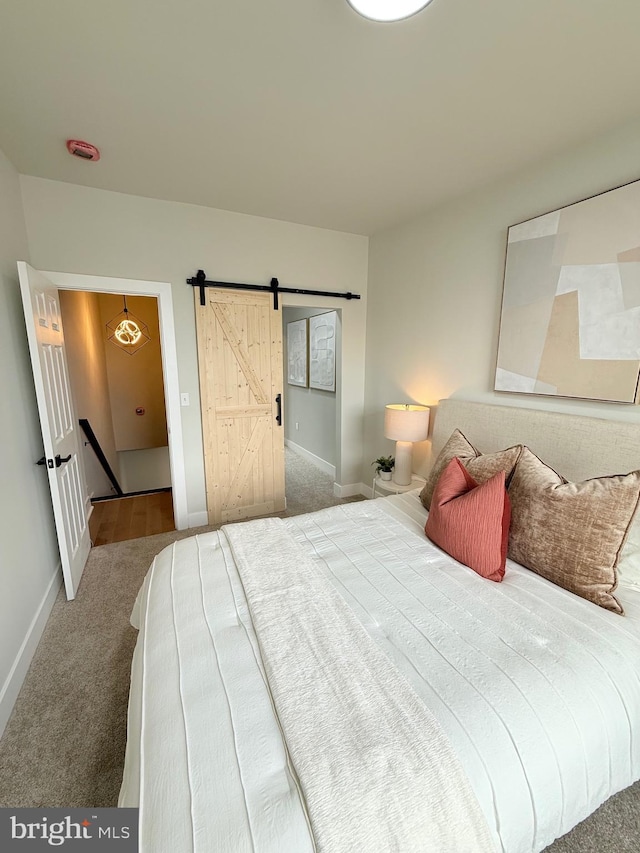 2112 Llewelyn Ave, Baltimore, MD 21213 - carpeted bedroom featuring a barn door and baseboards