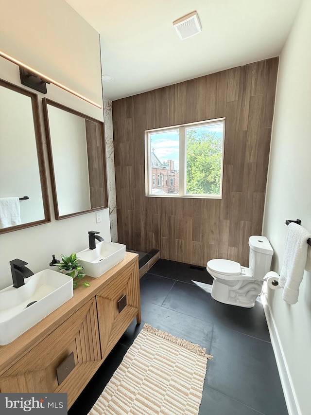 2112 Llewelyn Ave, Baltimore, MD 21213 - bathroom with toilet, double vanity, and wooden walls