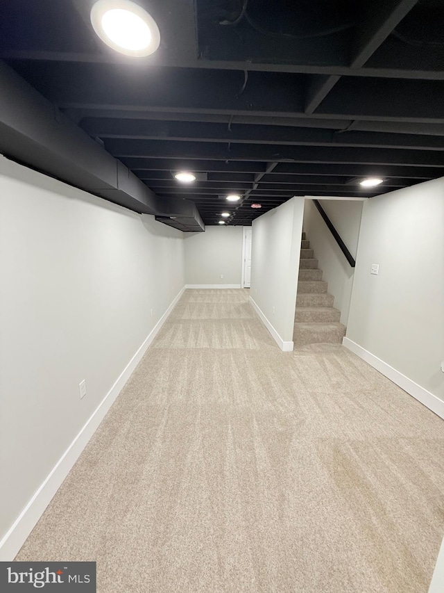 2112 Llewelyn Ave, Baltimore, MD 21213 - finished basement with carpet flooring, baseboards, and stairway