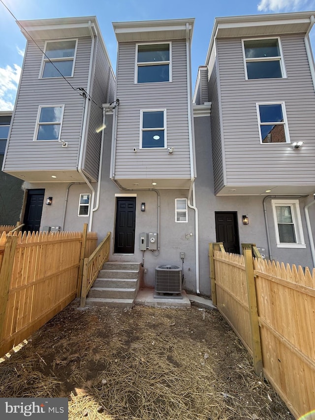 2112 Llewelyn Ave, Baltimore, MD 21213 - rear view of property with central AC, stucco siding, and entry steps