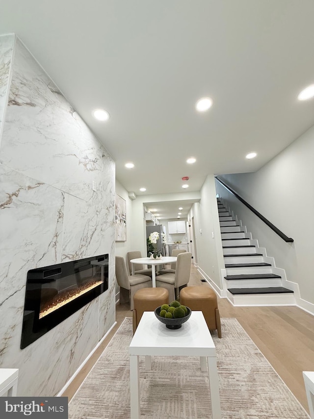 2112 Llewelyn Ave, Baltimore, MD 21213 - living area with a premium fireplace, stairway, recessed lighting, wood finished floors, and baseboards