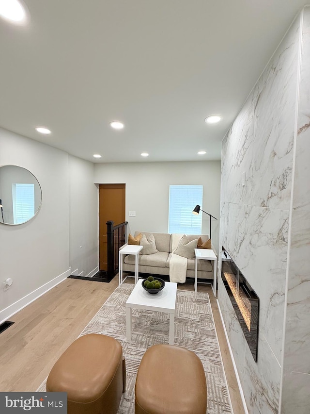 2112 Llewelyn Ave, Baltimore, MD 21213 - living room featuring recessed lighting, wood finished floors, a premium fireplace, and baseboards