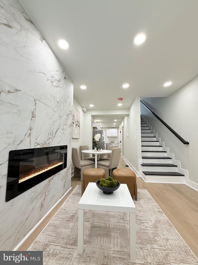 2112 Llewelyn Ave, Baltimore, MD 21213 - living area with recessed lighting, stairs, a premium fireplace, wood finished floors, and baseboards