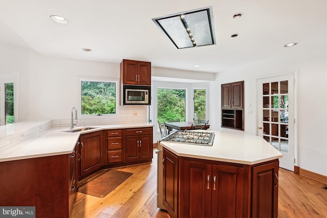 6662 Van Winkle Dr, Falls Church, VA 22044 - kitchen featuring appliances with stainless steel finishes, tasteful backsplash, light wood finished floors, light countertops, and recessed lighting