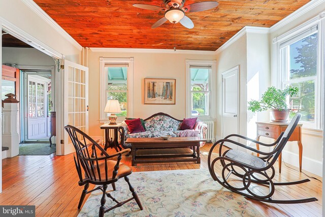 922 8th Ave, Prospect Park, PA 19076 - living area with light wood-style floors, crown molding, healthy amount of natural light, and wooden ceiling