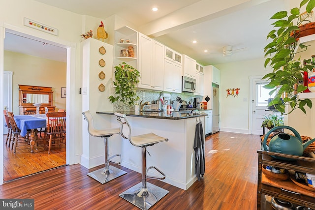 922 8th Ave, Prospect Park, PA 19076 - kitchen with stainless steel appliances, open shelves, tasteful backsplash, dark wood-type flooring, and white cabinetry