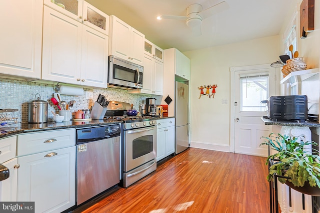 922 8th Ave, Prospect Park, PA 19076 - kitchen with stainless steel appliances, light wood finished floors, tasteful backsplash, a ceiling fan, and white cabinets