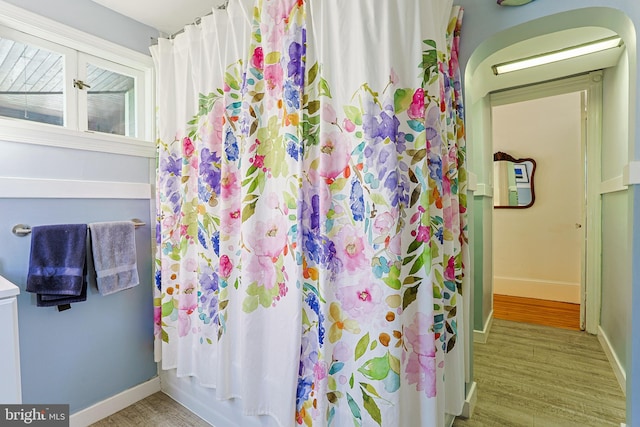922 8th Ave, Prospect Park, PA 19076 - full bathroom with wood finished floors, baseboards, and curtained shower