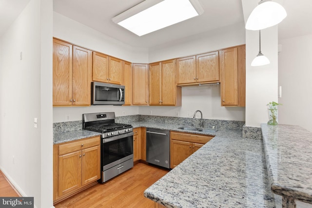 13800 Breezy Ridge Way Unit 101, Woodbridge, VA 22191 - kitchen with appliances with stainless steel finishes, light wood finished floors, a sink, and light stone counters