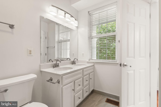 13800 Breezy Ridge Way Unit 101, Woodbridge, VA 22191 - bathroom featuring double vanity, toilet, and baseboards