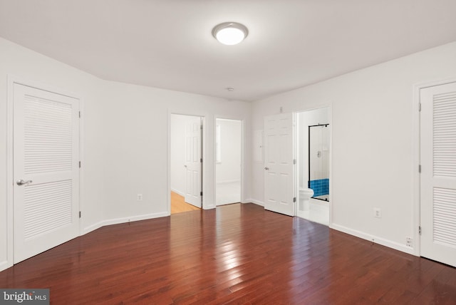13800 Breezy Ridge Way Unit 101, Woodbridge, VA 22191 - unfurnished bedroom with wood finished floors, baseboards, and ensuite bathroom