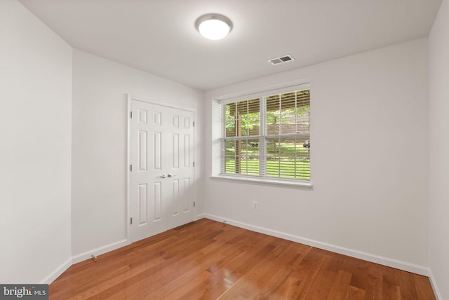 13800 Breezy Ridge Way Unit 101, Woodbridge, VA 22191 - unfurnished bedroom featuring light wood-type flooring, baseboards, and a closet