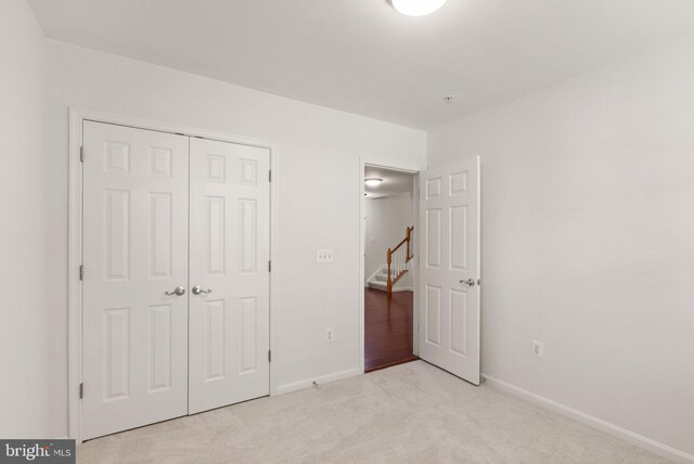 13800 Breezy Ridge Way Unit 101, Woodbridge, VA 22191 - unfurnished bedroom featuring light colored carpet, a closet, and baseboards