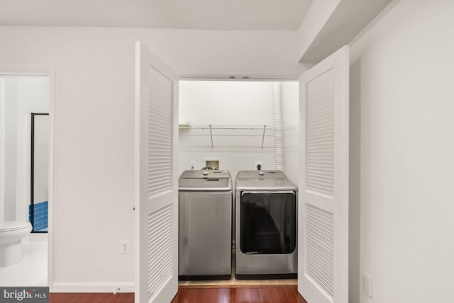 13800 Breezy Ridge Way Unit 101, Woodbridge, VA 22191 - washroom featuring washing machine and dryer, wood finished floors, and baseboards