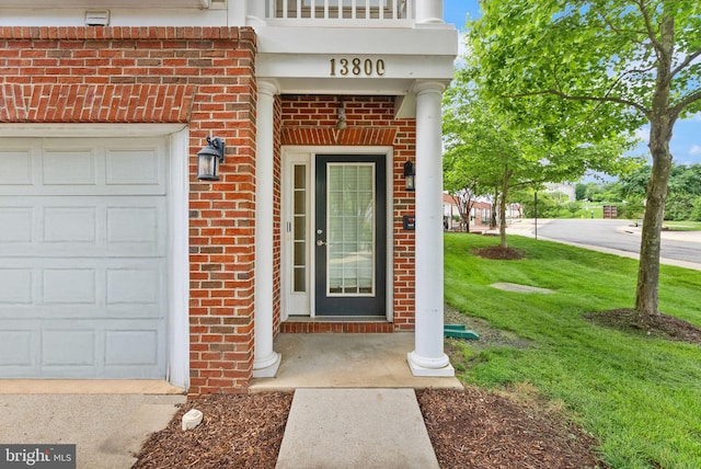 13800 Breezy Ridge Way Unit 101, Woodbridge, VA 22191 - view of exterior entry featuring brick siding, an attached garage, and a yard