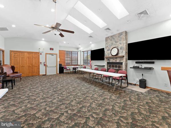 902 Scotswood Ct, Mount Laurel, NJ 08054 - living room featuring carpet floors, a skylight, a stone fireplace, recessed lighting, and a ceiling fan