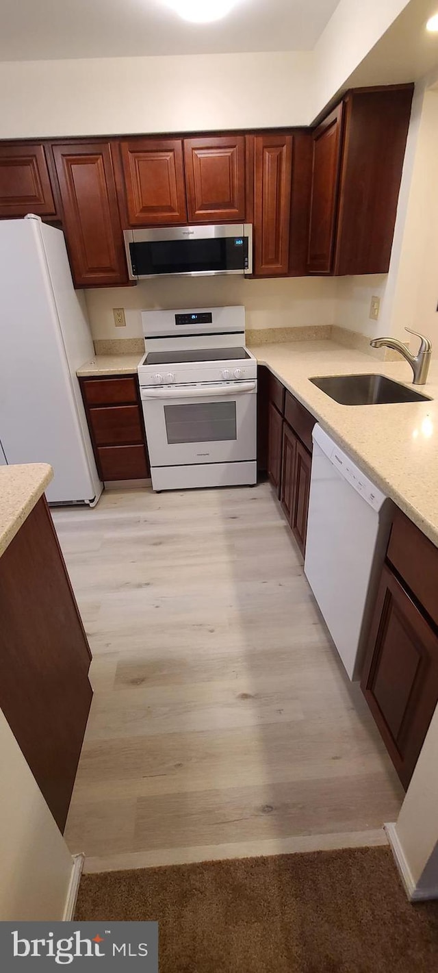 902 Scotswood Ct, Mount Laurel, NJ 08054 - kitchen with white appliances, a sink, light wood finished floors, and light stone countertops