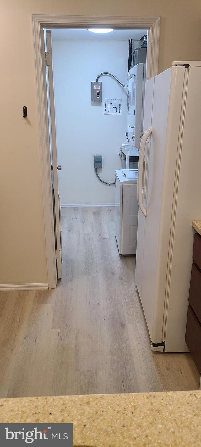 902 Scotswood Ct, Mount Laurel, NJ 08054 - kitchen with stacked washing machine and dryer, freestanding refrigerator, light wood finished floors, and electric panel