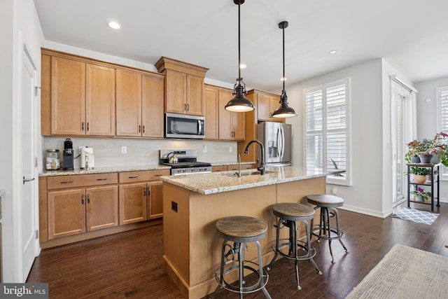 131 Junction Rd, Media, PA 19063 - kitchen with stainless steel appliances, a sink, dark wood-style flooring, a kitchen island with sink, and baseboards