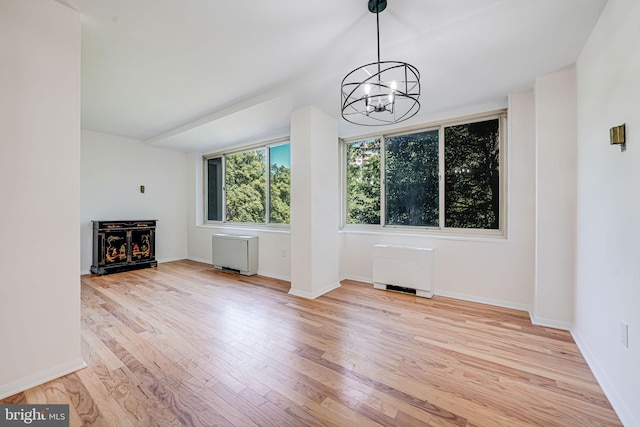 4000 Tunlaw Rd NW Unit 602, Washington, DC 20007 - unfurnished living room featuring a chandelier, wood finished floors, and baseboards