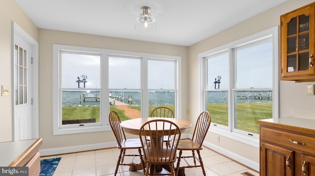 1702 Ferry Point Ct, Trappe, MD 21673 - dining space with baseboards, light tile patterned flooring, and a water view