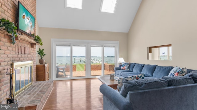 1702 Ferry Point Ct, Trappe, MD 21673 - living area with high vaulted ceiling, wood finished floors, and a fireplace