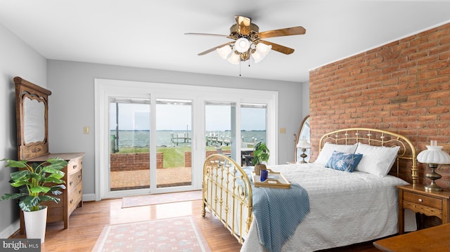 1702 Ferry Point Ct, Trappe, MD 21673 - bedroom featuring access to outside, light wood-type flooring, brick wall, ceiling fan, and baseboards